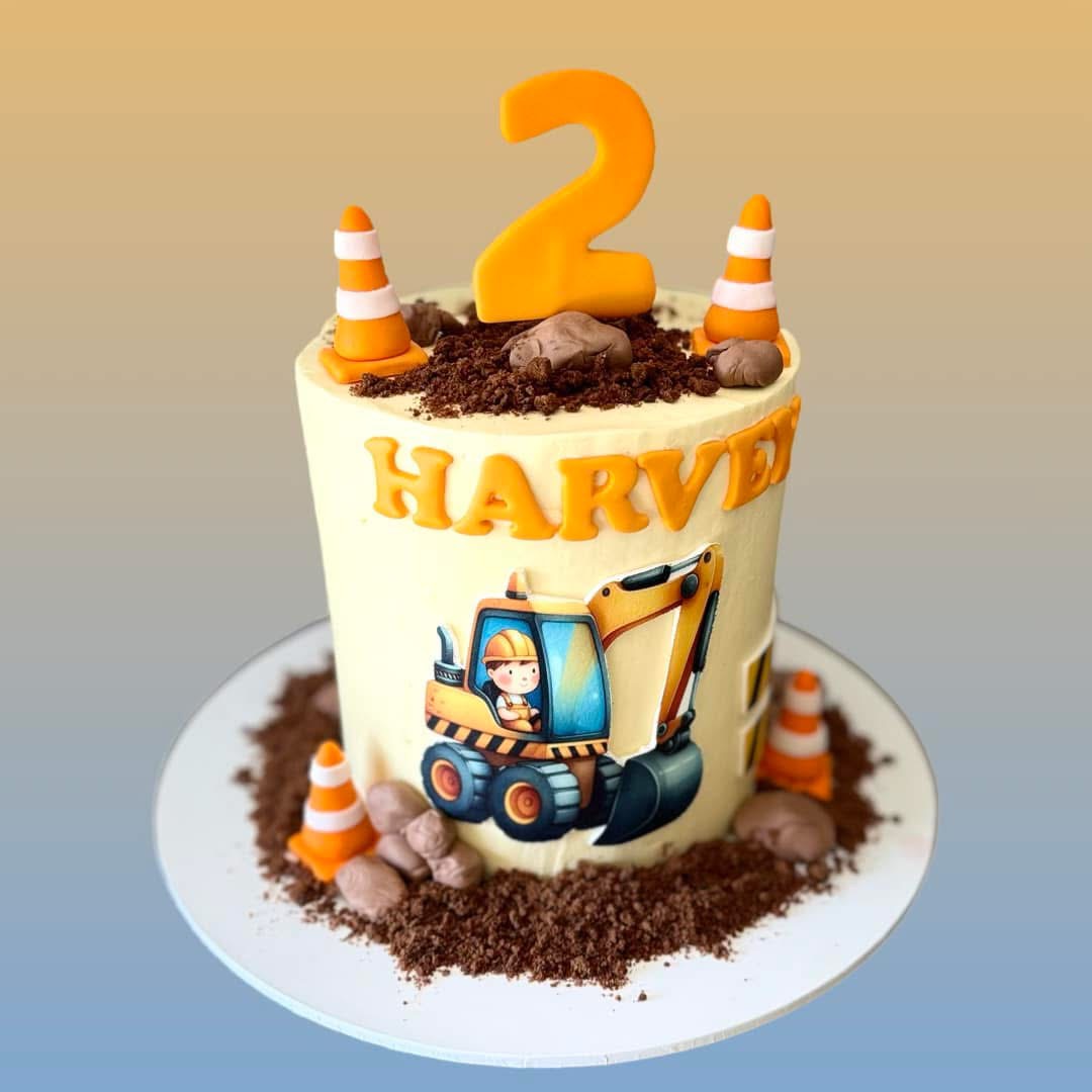 Personalised second birthday cake with construction vehicles and orange decorations